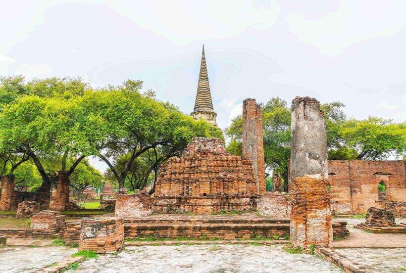 Ayutthaya One Day: Famous Temples & Bang Pa-In Palace Tour - Wat Yai Chai Mongkhon: long chedi views and statue rows